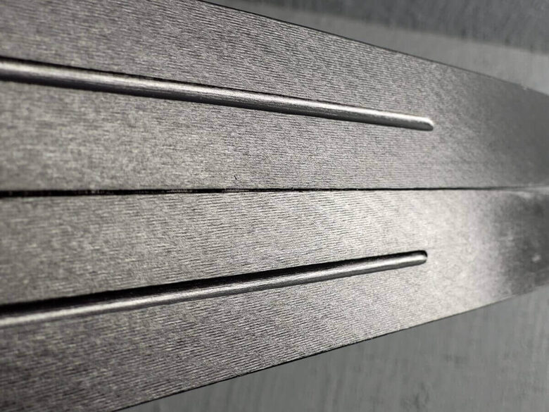 One pair of skis featuring newly created ski base structure made with Svecom stone grinding machine for high-performance skiing.